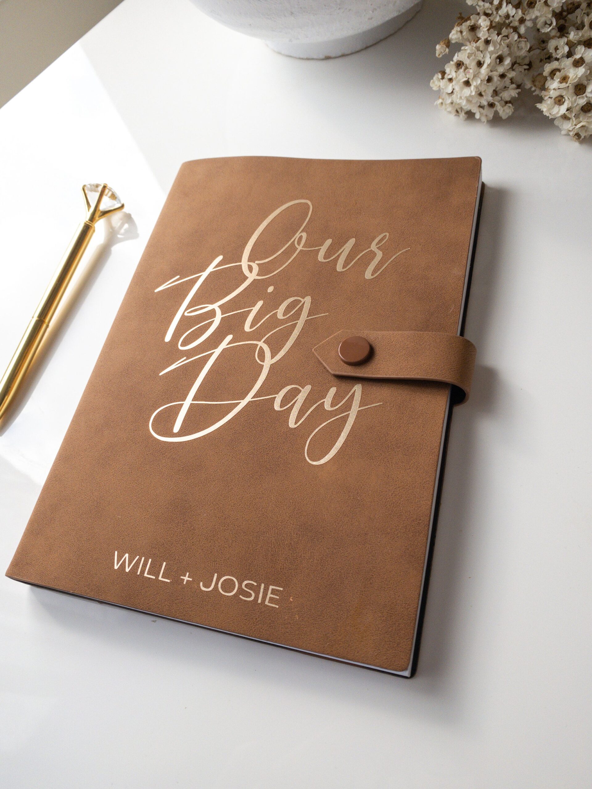 couple interviewing wedding planner with notebook