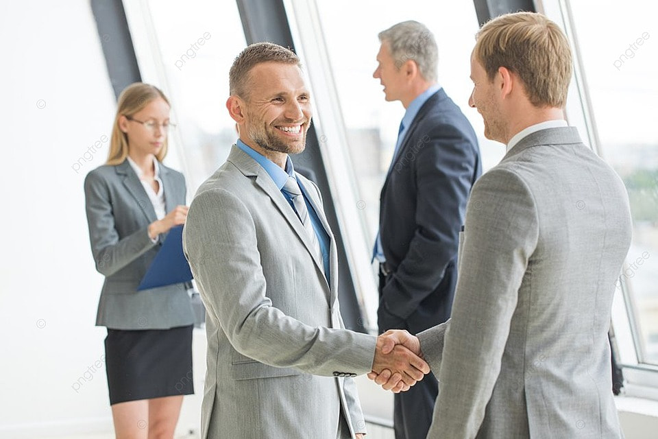 couple meeting wedding planner in bright studio shaking hands