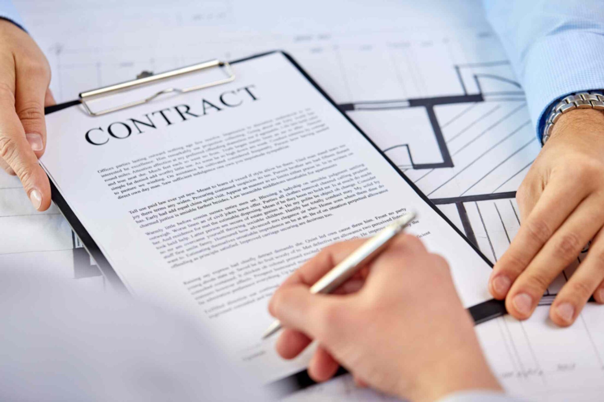 planner and couple signing contract paperwork