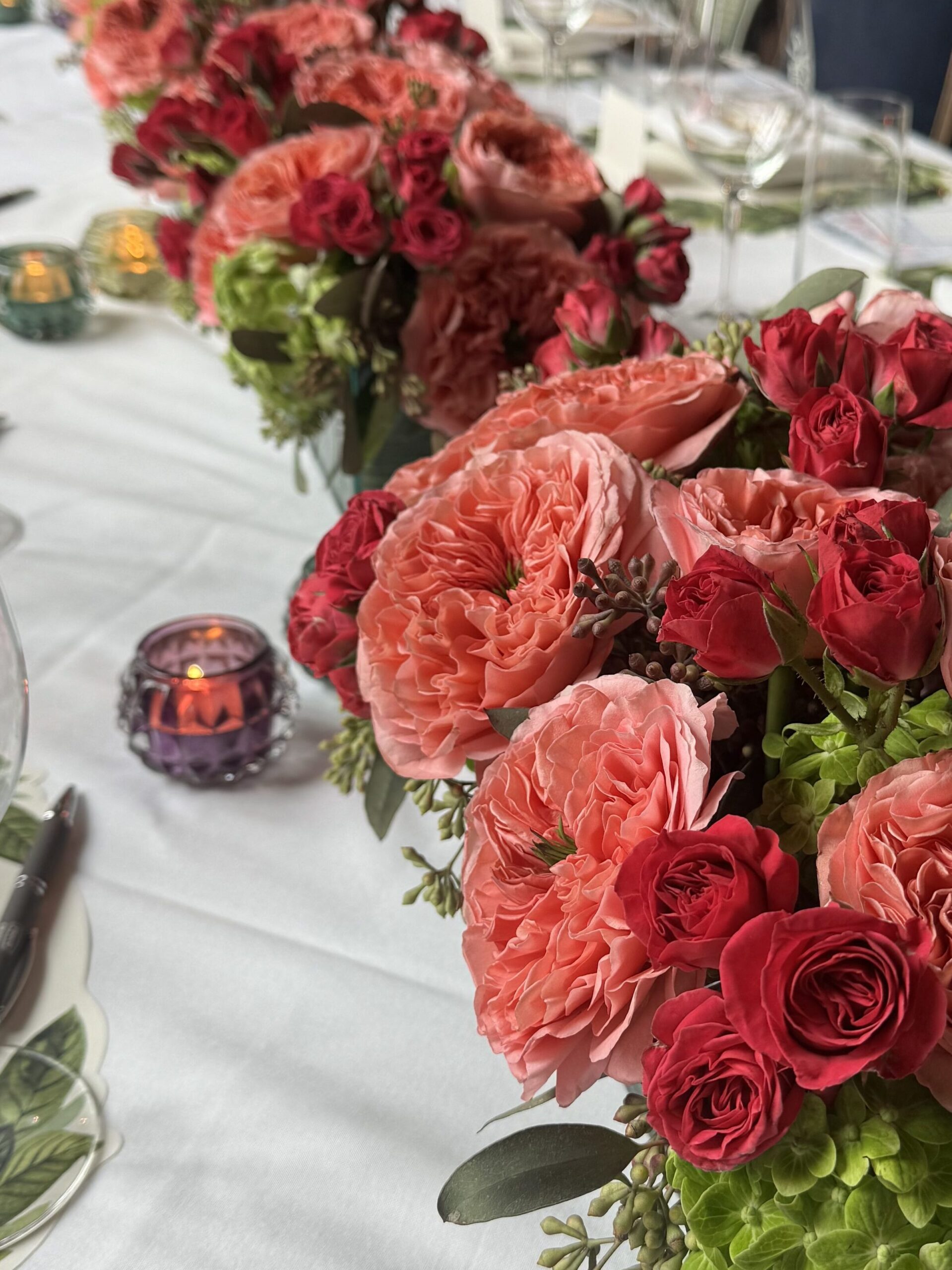 wedding planner arranging reception florals before guests arrive