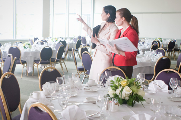 wedding planner coordinating staff at reception